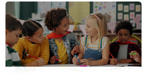 Children engaged in a spelling or writing activity at a classroom table