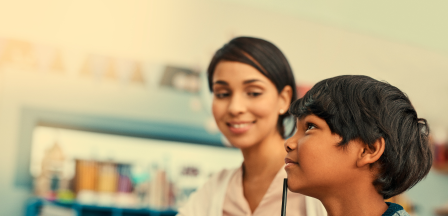 Student solving a problem while teacher observes
